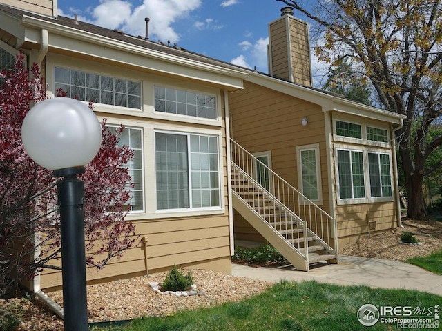 6036 Gunbarrel Ave Unit B, Boulder, CO 80301 - view of side of home featuring stairway and a chimney