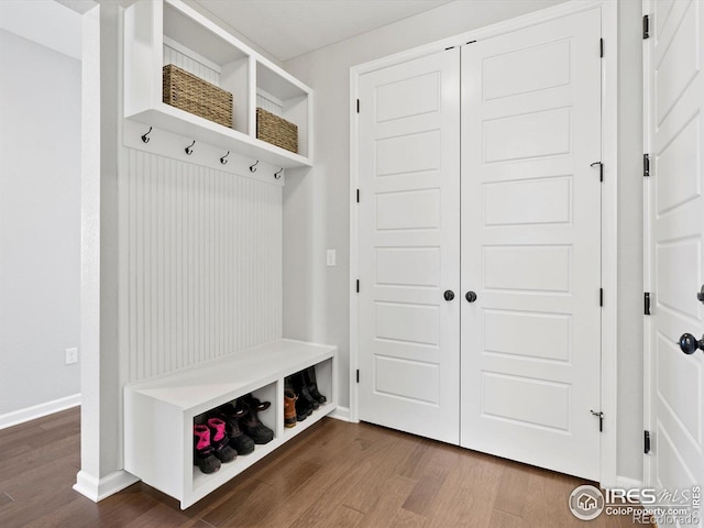 mudroom featuring baseboards and dark wood finished floors