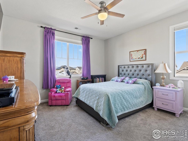 bedroom featuring multiple windows, light colored carpet, and visible vents