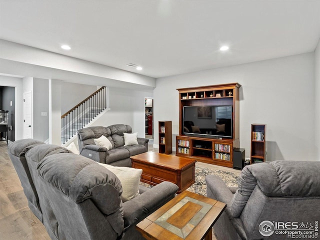 living room with stairway, recessed lighting, wood finished floors, and visible vents