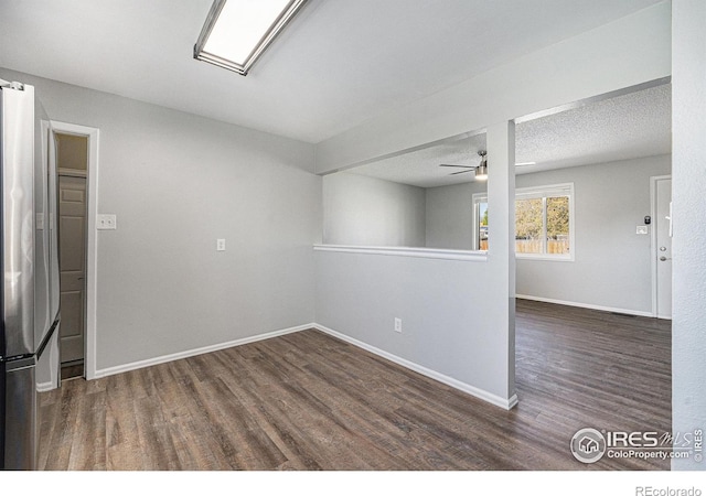 unfurnished room with a ceiling fan, baseboards, and wood finished floors