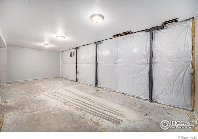 unfinished basement with a textured ceiling and visible vents