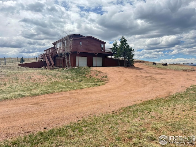115 Arapaho Ridge Rd, Livermore, CO 80536 - exterior space with fence, driveway, and a garage