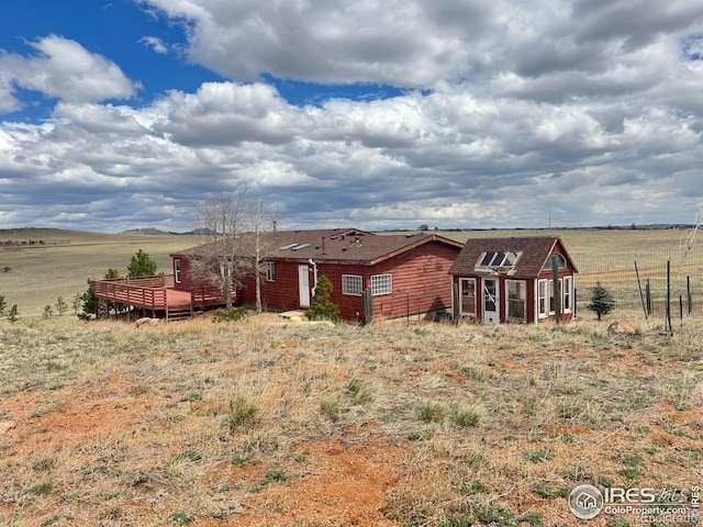 115 Arapaho Ridge Rd, Livermore, CO 80536 - back of property with roof with shingles, a wooden deck, and a rural view