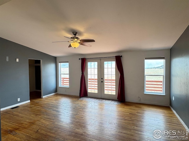 115 Arapaho Ridge Rd, Livermore, CO 80536 - empty room featuring a ceiling fan, french doors, vaulted ceiling, wood finished floors, and baseboards