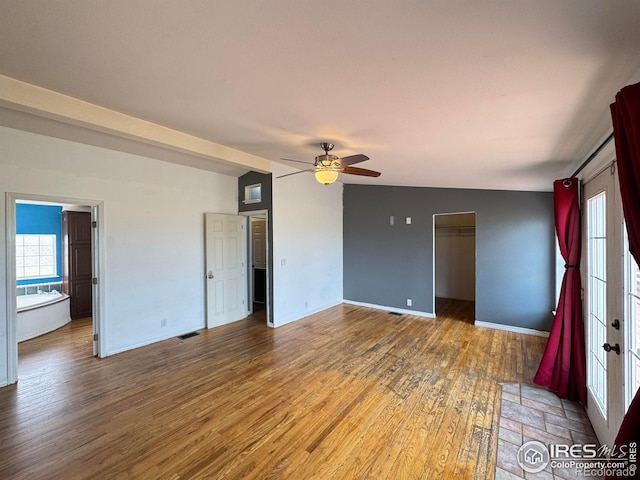 115 Arapaho Ridge Rd, Livermore, CO 80536 - unfurnished room featuring ceiling fan, visible vents, a wealth of natural light, and wood finished floors