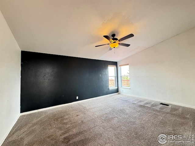115 Arapaho Ridge Rd, Livermore, CO 80536 - carpeted spare room with baseboards, ceiling fan, vaulted ceiling, and visible vents