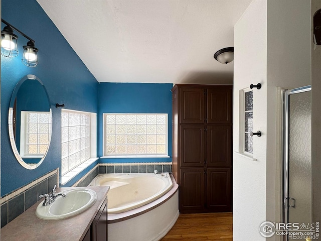 115 Arapaho Ridge Rd, Livermore, CO 80536 - full bathroom featuring vanity, a whirlpool tub, a stall shower, and wood finished floors