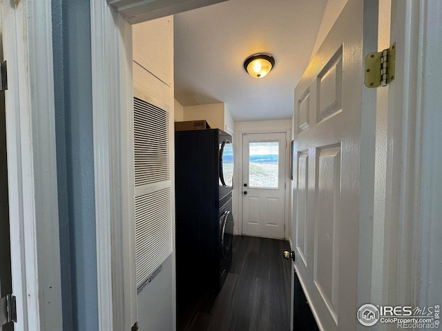 115 Arapaho Ridge Rd, Livermore, CO 80536 - washroom featuring laundry area, a heating unit, dark wood finished floors, and stacked washer / dryer