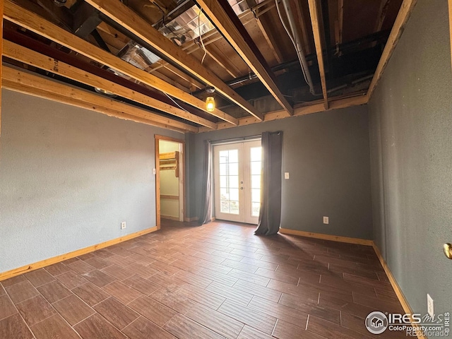 115 Arapaho Ridge Rd, Livermore, CO 80536 - spare room featuring baseboards, a textured wall, french doors, and wood finish floors