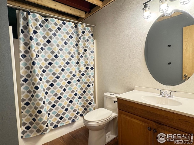 115 Arapaho Ridge Rd, Livermore, CO 80536 - full bathroom with a textured wall, toilet, and wood finished floors