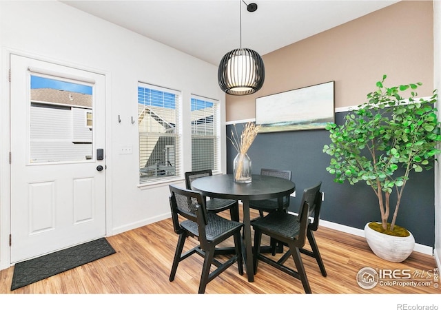 2832 William Neal Pkwy Unit C, Fort Collins, CO 80525 - dining area with an inviting chandelier, baseboards, and light wood-type flooring