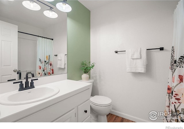 2832 William Neal Pkwy Unit C, Fort Collins, CO 80525 - bathroom with wood finished floors, vanity, baseboards, toilet, and a shower with shower curtain