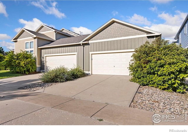 2832 William Neal Pkwy Unit C, Fort Collins, CO 80525 - multi unit property featuring a garage, a shingled roof, board and batten siding, and driveway
