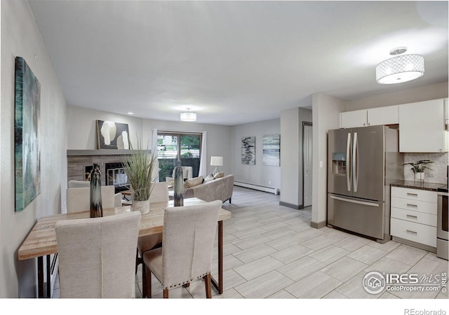 3785 Birchwood Dr, Boulder, CO 80304 - dining space featuring baseboards, baseboard heating, and a glass covered fireplace