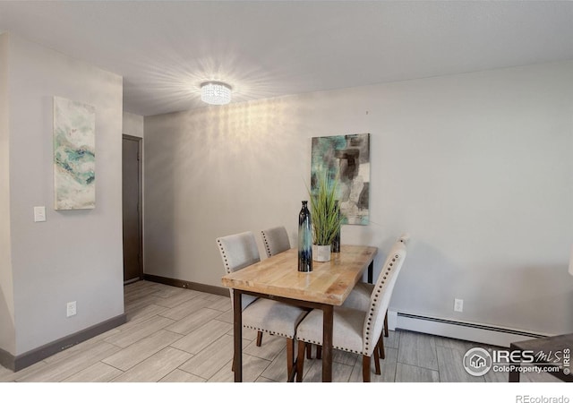 3785 Birchwood Dr, Boulder, CO 80304 - dining room featuring baseboards, wood tiled floor, and a baseboard heating unit
