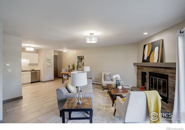 3785 Birchwood Dr, Boulder, CO 80304 - living room featuring recessed lighting, a baseboard heating unit, baseboards, a glass covered fireplace, and light wood-style floors