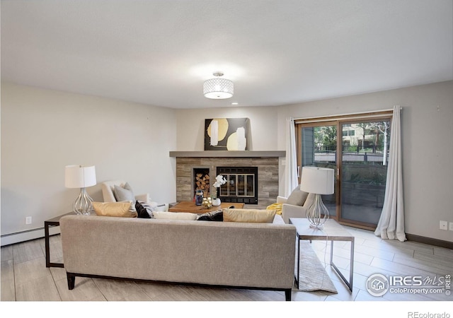 3785 Birchwood Dr, Boulder, CO 80304 - living area with baseboards, light wood-style floors, baseboard heating, and a glass covered fireplace