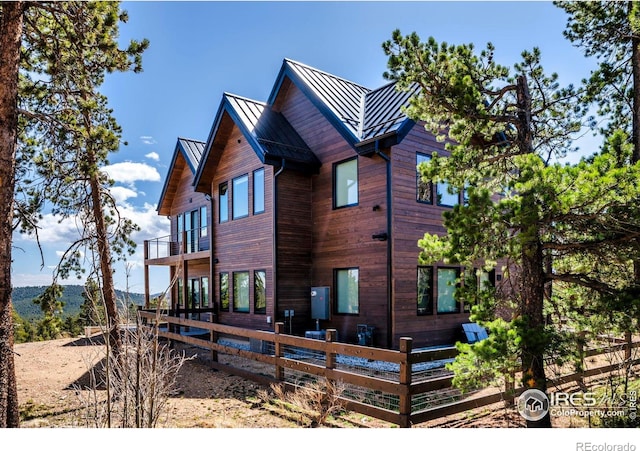 11 Juneau Cir, Nederland, CO 80466 - rear view of property featuring fence, a standing seam roof, metal roof, and a balcony