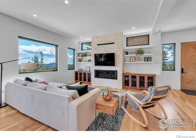 11 Juneau Cir, Nederland, CO 80466 - living room with recessed lighting, baseboards, wood finished floors, and a fireplace