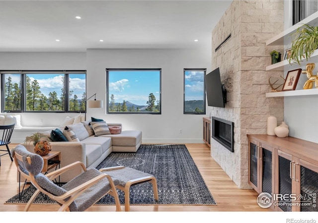 11 Juneau Cir, Nederland, CO 80466 - living area with a stone fireplace, recessed lighting, and light wood finished floors