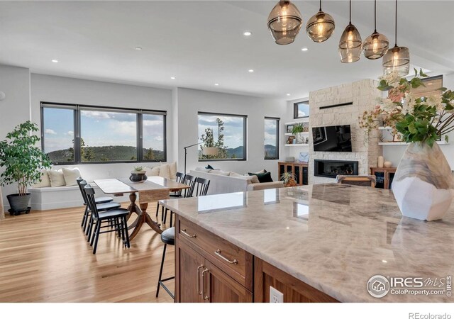 11 Juneau Cir, Nederland, CO 80466 - kitchen featuring plenty of natural light, brown cabinetry, a kitchen bar, and open floor plan