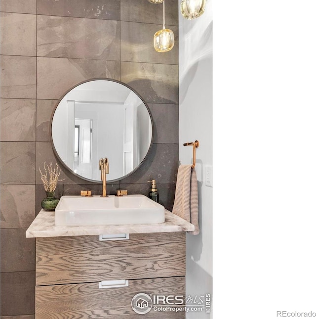 11 Juneau Cir, Nederland, CO 80466 - bathroom with tile walls, tasteful backsplash, and vanity