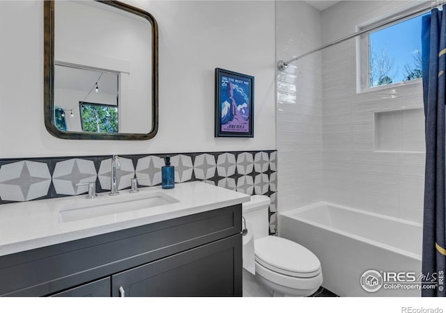 11 Juneau Cir, Nederland, CO 80466 - bathroom featuring vanity, toilet, tile walls, a wainscoted wall, and  shower combination