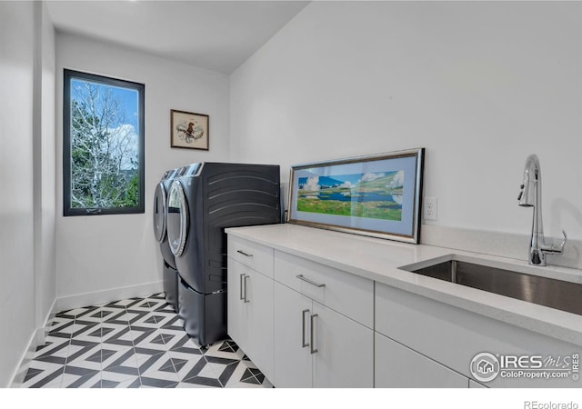 11 Juneau Cir, Nederland, CO 80466 - laundry area with separate washer and dryer, a sink, cabinet space, and baseboards