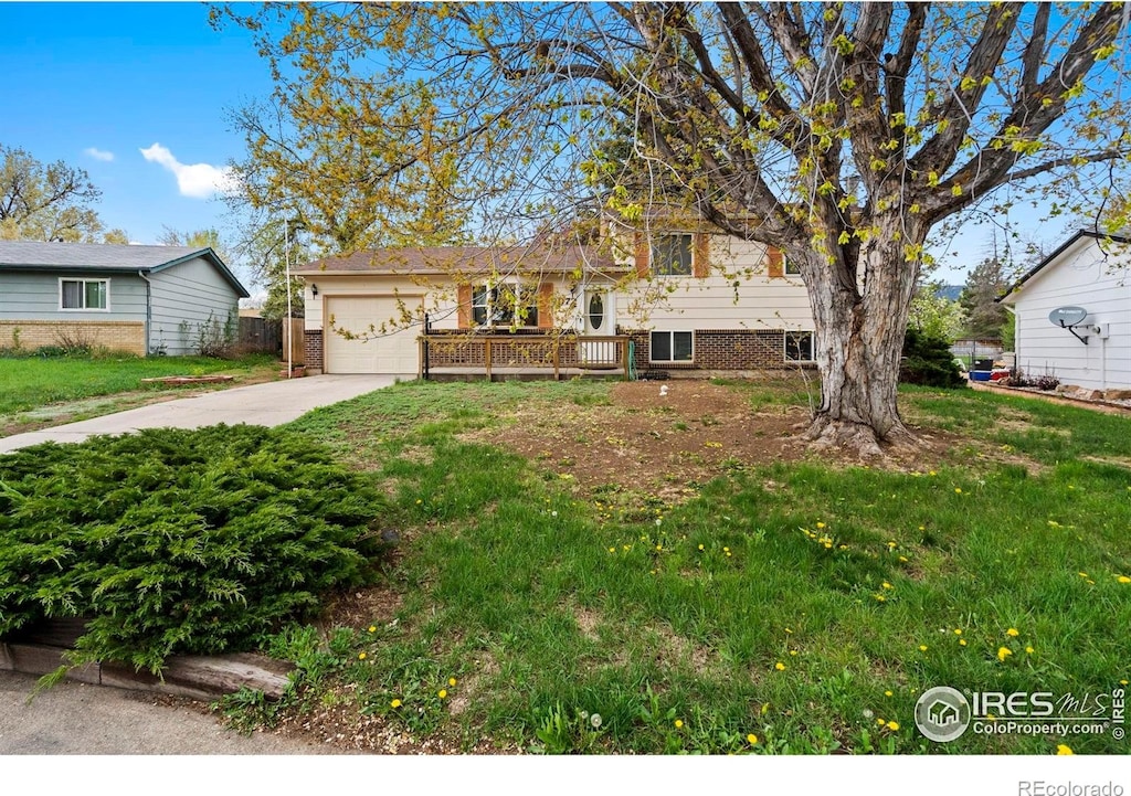 1972 Dorset Dr, Fort Collins, CO 80526 - tri-level home featuring a garage, driveway, a front lawn, and brick siding
