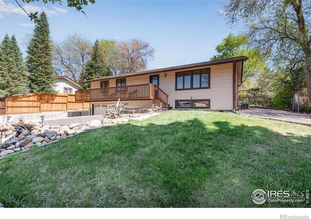 view of front of home with a wooden deck and an attached garage