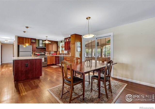 dining room with dark wood finished floors and baseboards