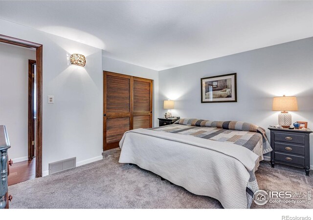 bedroom featuring carpet, a closet, and baseboards