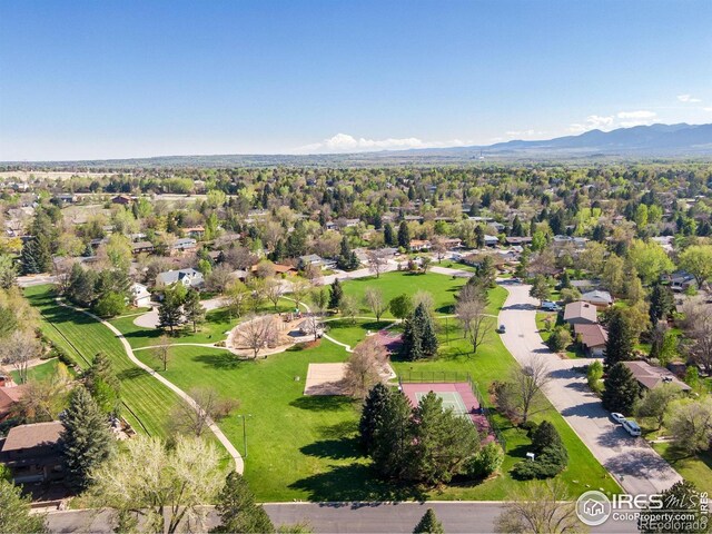 aerial view of property's location featuring mountains and nearby suburban area
