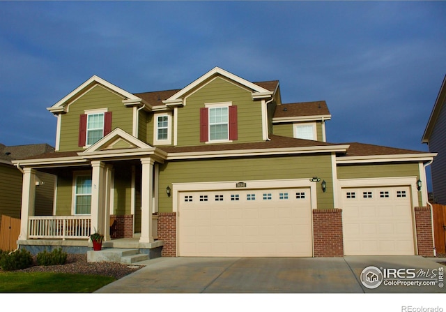 craftsman inspired home featuring brick siding, a garage, driveway, and a porch