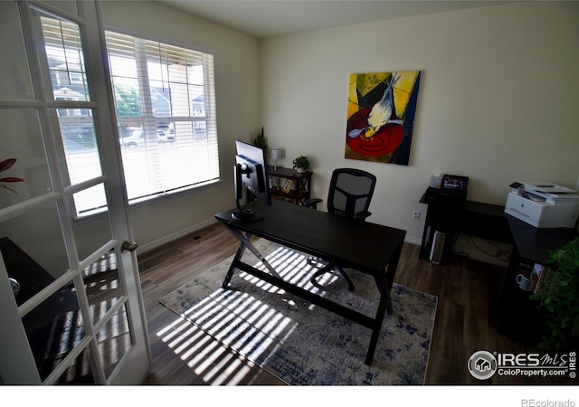 home office featuring baseboards and wood finished floors