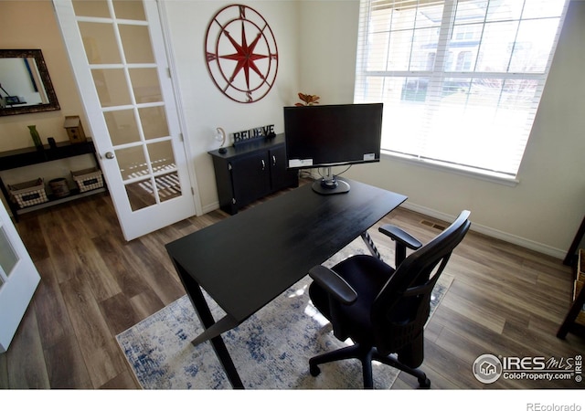 office area with baseboards and wood finished floors
