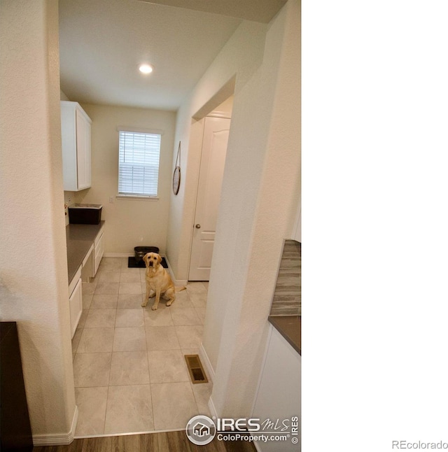 interior space with visible vents, recessed lighting, baseboards, and light tile patterned floors
