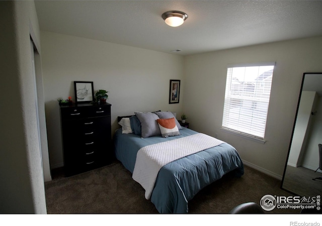 carpeted bedroom with baseboards