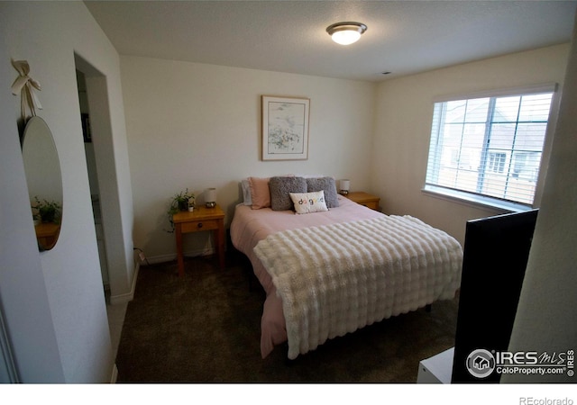 bedroom featuring carpet floors and baseboards