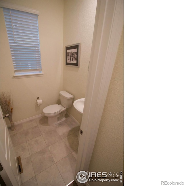 bathroom featuring toilet and tile patterned floors