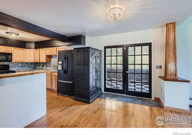 kitchen with french doors, light wood-style flooring, black appliances, and beamed ceiling