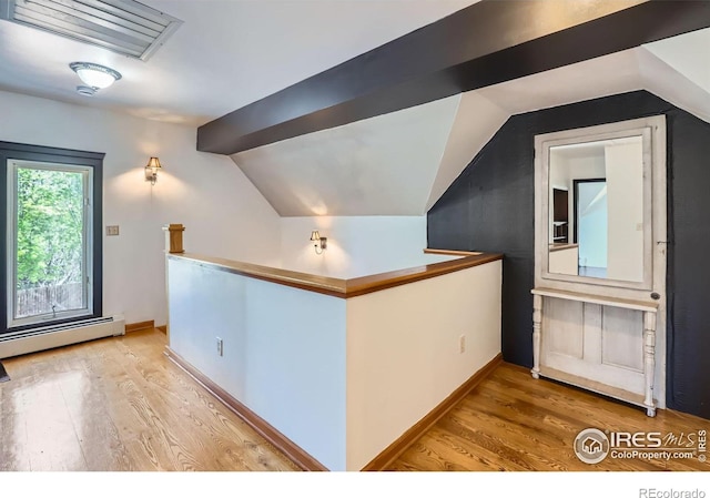 bonus room featuring baseboards, vaulted ceiling, light wood-style flooring, and a baseboard radiator