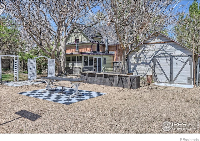 back of property with a patio and brick siding