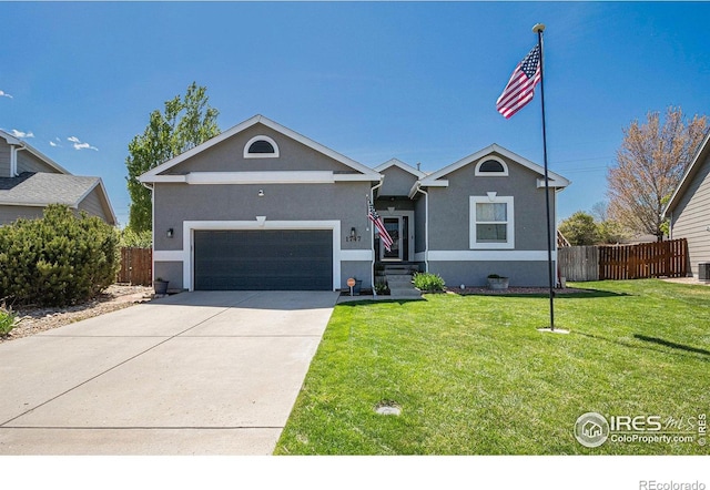 ranch-style house featuring fence, stucco siding, a front lawn, and a garage