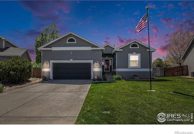 single story home with concrete driveway, fence, a front lawn, and stucco siding
