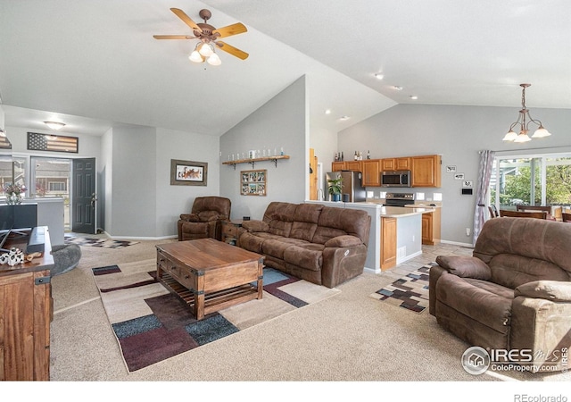 living area featuring high vaulted ceiling, baseboards, ceiling fan with notable chandelier, and light colored carpet
