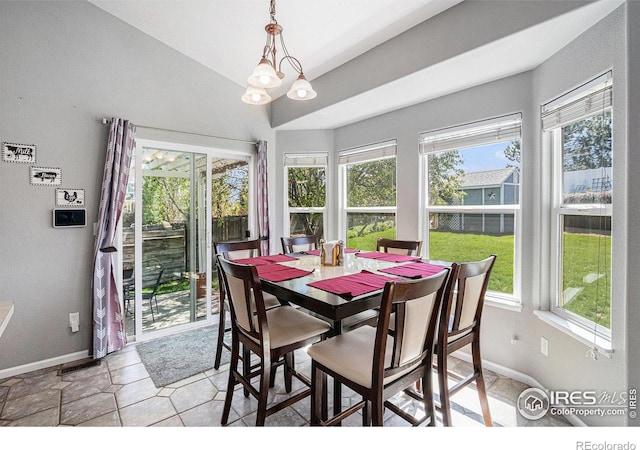 dining space with baseboards, vaulted ceiling, and a wealth of natural light