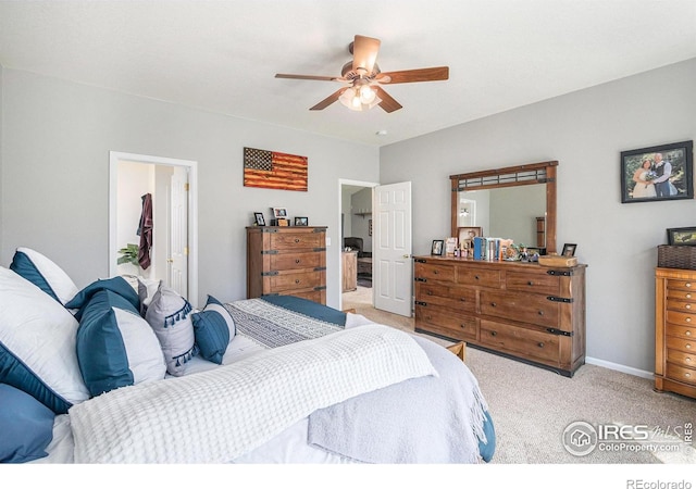 bedroom with baseboards, ceiling fan, and light carpet