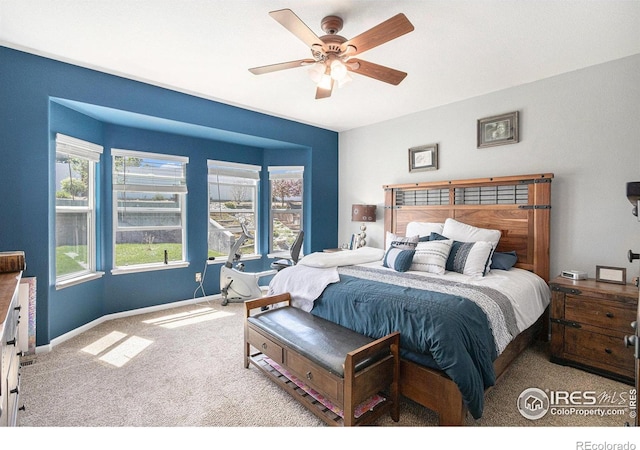 carpeted bedroom with a ceiling fan and baseboards